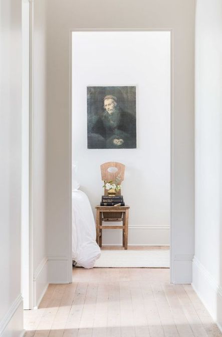 Looking into the bedroom, a timeless print rests above an old schoolhouse chair. (Photography by Alyssa Rosenheck)