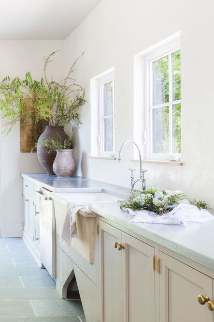 Natural light floods the space from square windows above the farmhouse sink. (Photography by Alyssa Rosenheck)