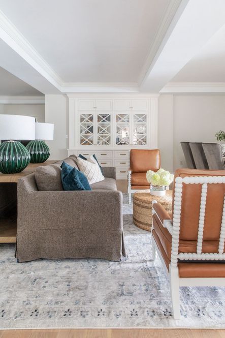 SHOP THE LOOK: Rhonwen Table Lamp, Catalina Ivory Pillow, Melia Juniper Pillows, White Colorblock Vase, Lamar Console Table, Adele Round Woven Ottoman, Anastasia Blue/Slate Rug