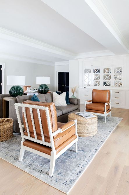 SHOP THE LOOK: Rhonwen Table Lamp, Catalina Ivory Pillow, Melia Juniper Pillows, Lamar Console Table, Adele Round Woven Ottoman, Anastasia Blue/Slate Rug