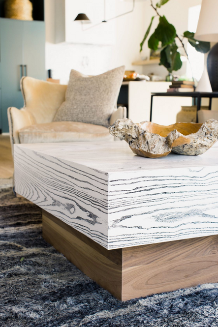 This two-toned wood coffee table introduces a variety of textures and colors into the space.