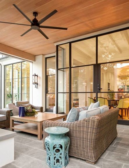 Space to entertain inside and out is a must in any home, and we could personally spend all day out here! Every detail from the ceiling fan to the colored accent table pull everything together beautifully.