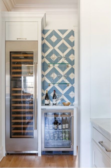 Patterned tile adds visual interest to the wine cooler and bar area.