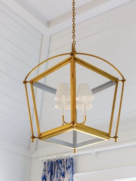 This lighting fixture combines the styles of lantern/caged lighting and a traditional lamp shade.