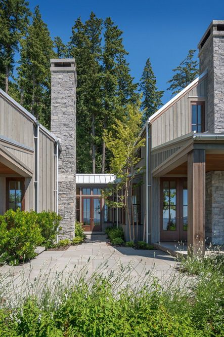 Due to the small lot size, they had to be strategic on how to optimize natural light in the square house. They decided to build two structures with a glassed-in breezeway in between to let the sun in from all angles of the home.Architecture by Hoedemaker Pfeiffer | Photo by Aaron Leitz | Project Chuckanut
