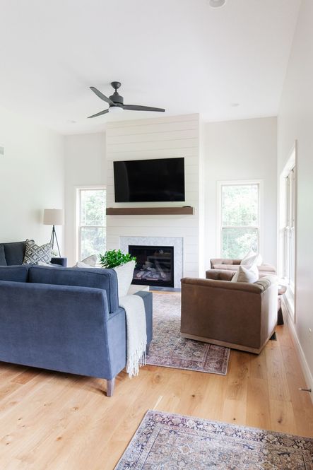 Captivating blue sofas bring vibrance to this neutral-toned space.