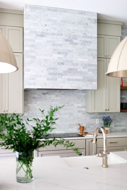 The polished nickel faucet and cabinet hardware are the perfect accent for the gray and blue tones of the marble tile.